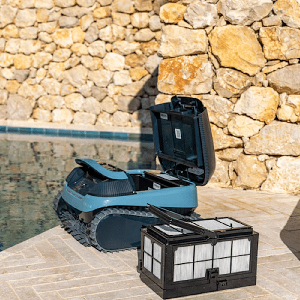 Dolphin Eon 120d with the lid open and filter basket removed beside it on the pool surround